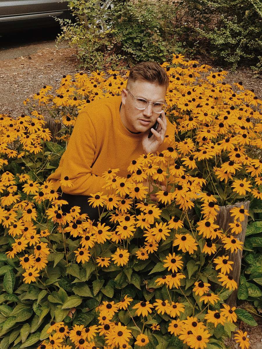 person man wearing brown sweater docking in sunflowers newberg